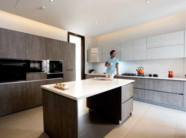 Island kitchen with stone counters and integrated appliances